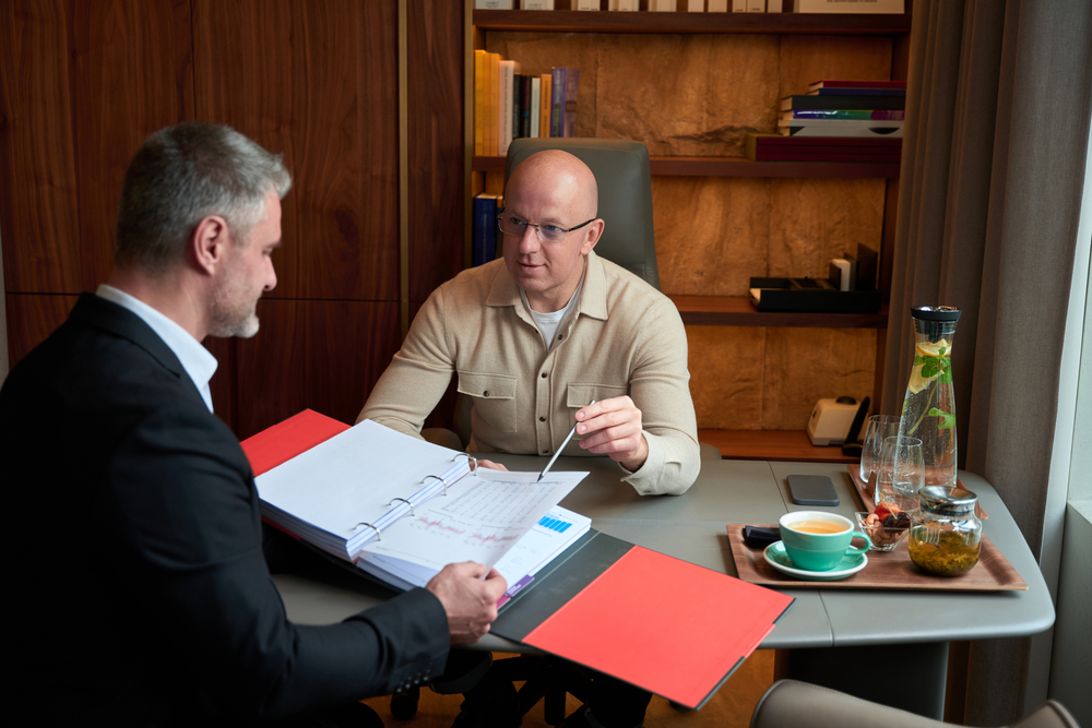 handsome european males are discussing something in the cabinet